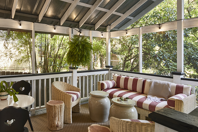 screened porch with cozy furnishings