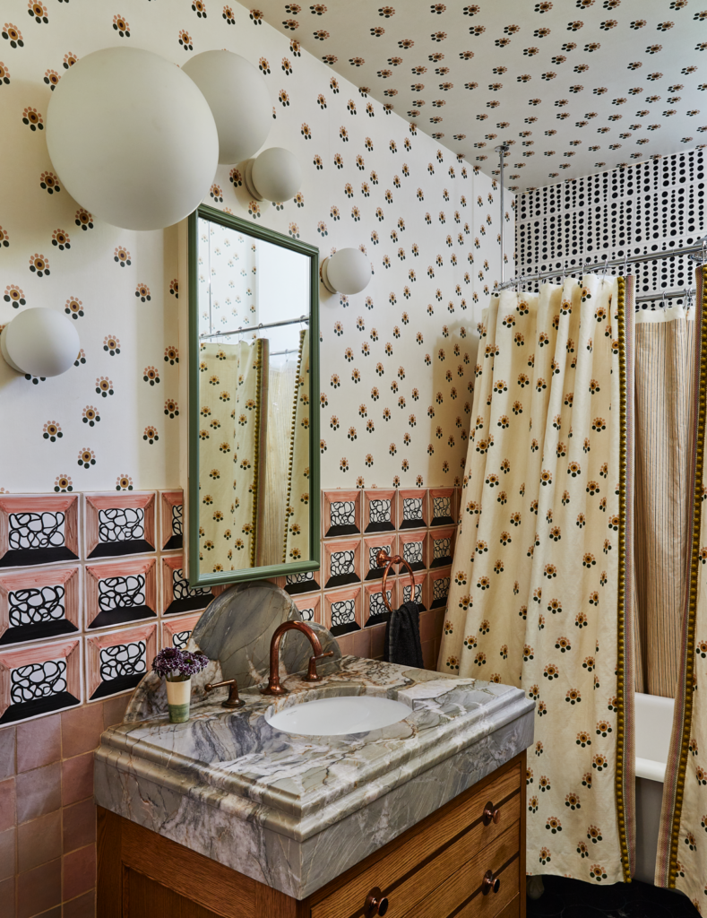 Marble sink in a renovated bathroom surrounded by different patterns and textures on the walls and ceiling.