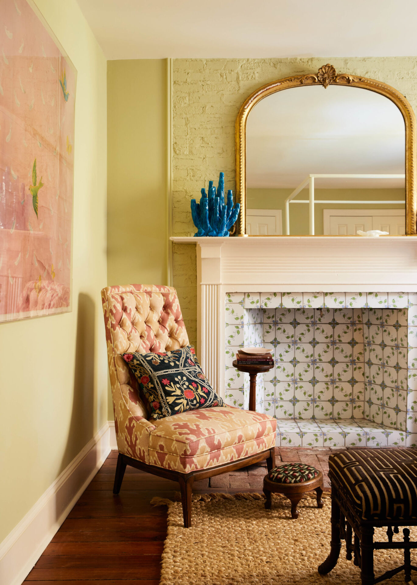 Renovated room with a patterned chair and colorful fireplace. 