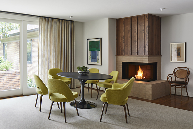 Retrofuturism in interior design dining room with green chairs.